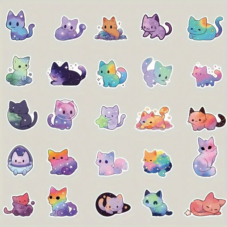 des stickers en forme de chat aux couleurs de la galaxie. Coloris multicolores, décorés d'étoiles et de nuages de toutes les couleurs.