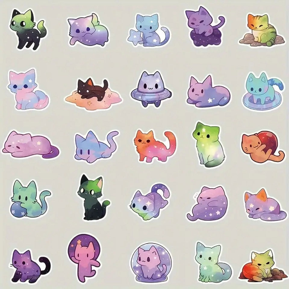 des stickers en forme de chat aux couleurs de la galaxie. Coloris multicolores, décorés d'étoiles et de nuages de toutes les couleurs.