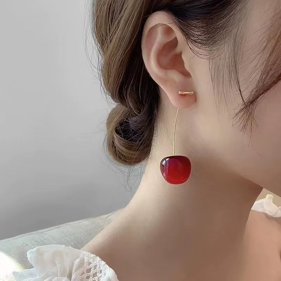 une paire de boucles d'oreilles adorables en forme de cerises rouges gourmandes