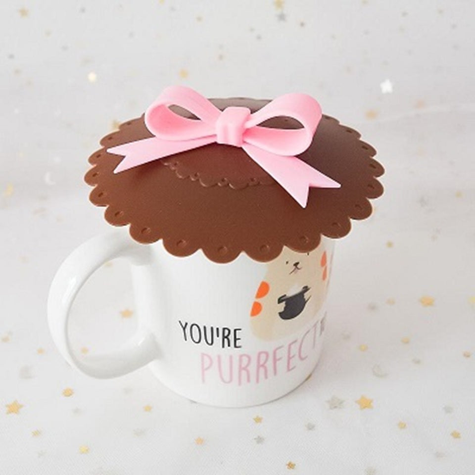 des couvre tasses comme des petits biscuits surmontés d'un adorable noeud rose. Idéal pour maintenir sa boisson au chaud ou la protéger des insectes. En silicone, ils sont résistants et durables.