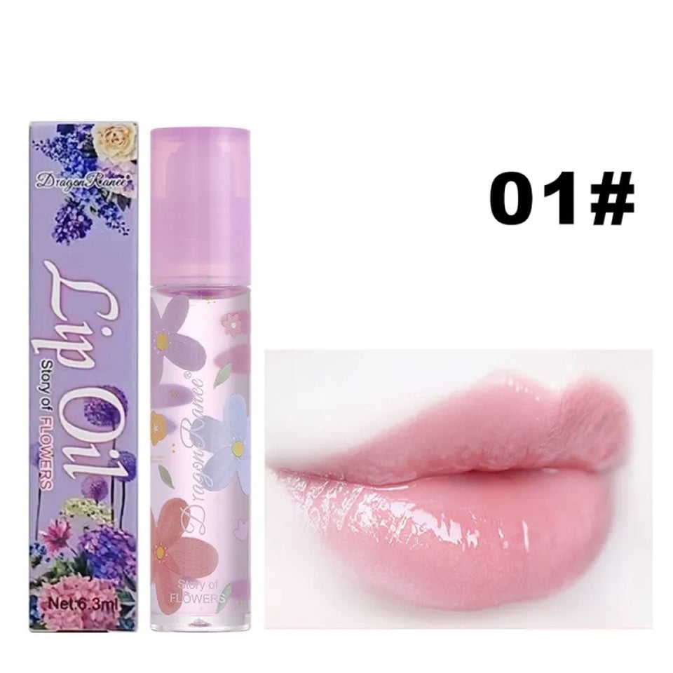 des huiles pour les lèvres aux doux doux parfums de fleurs. Les tubes sont colorés et en verre avec un design de fleurs.