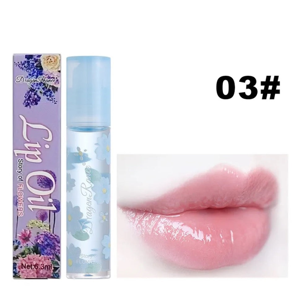 des huiles pour les lèvres aux doux doux parfums de fleurs. Les tubes sont colorés et en verre avec un design de fleurs.
