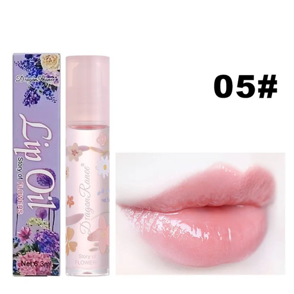 des huiles pour les lèvres aux doux doux parfums de fleurs. Les tubes sont colorés et en verre avec un design de fleurs.