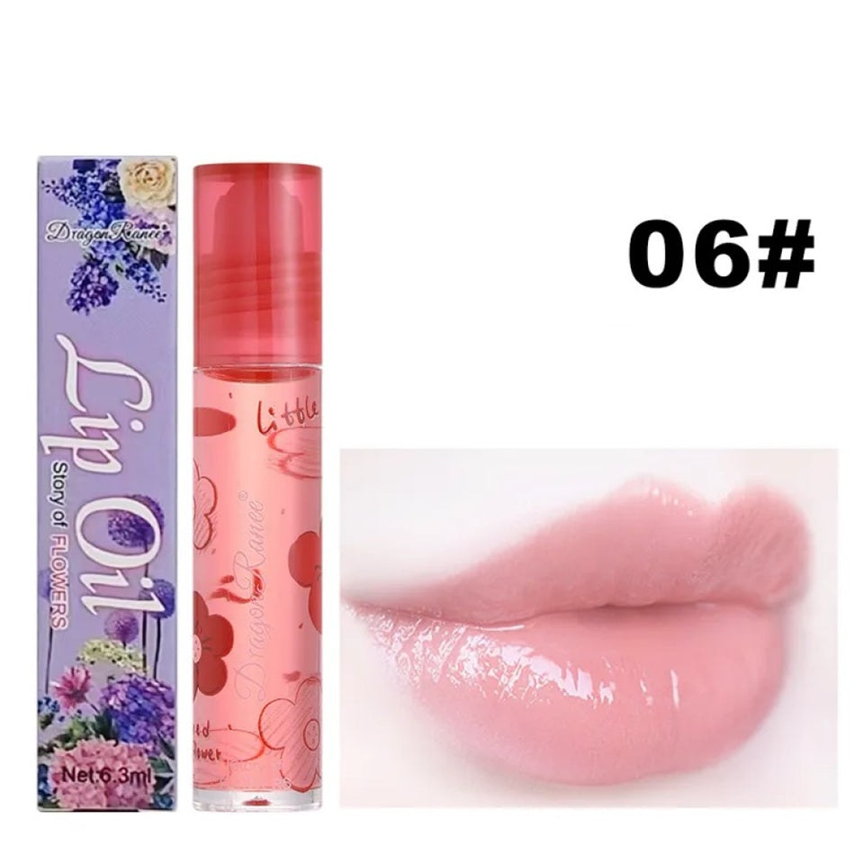 des huiles pour les lèvres aux doux doux parfums de fleurs. Les tubes sont colorés et en verre avec un design de fleurs.