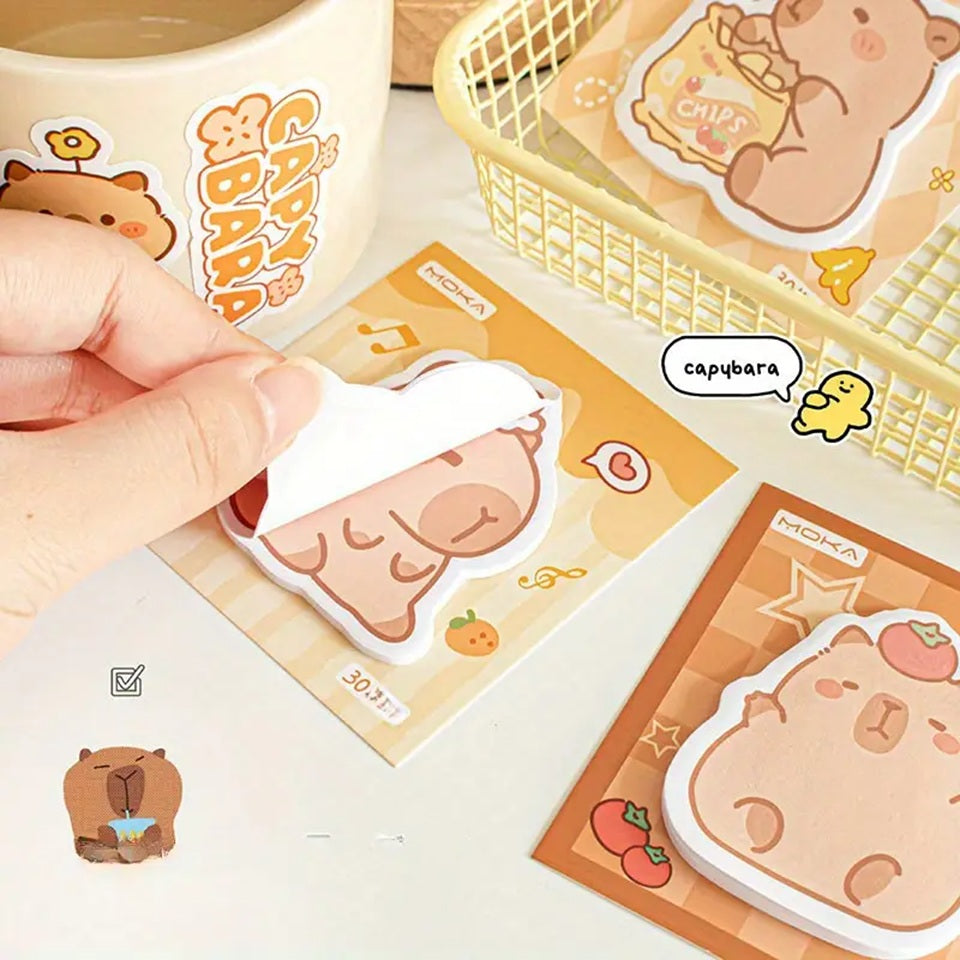 des mémos adhésifs inspirés des capybara. Avec leur expression calme et tendre, ils sont adorables. Dans des positions amusantes et mignonnes, ils sont parfaits pour laisser des messages.