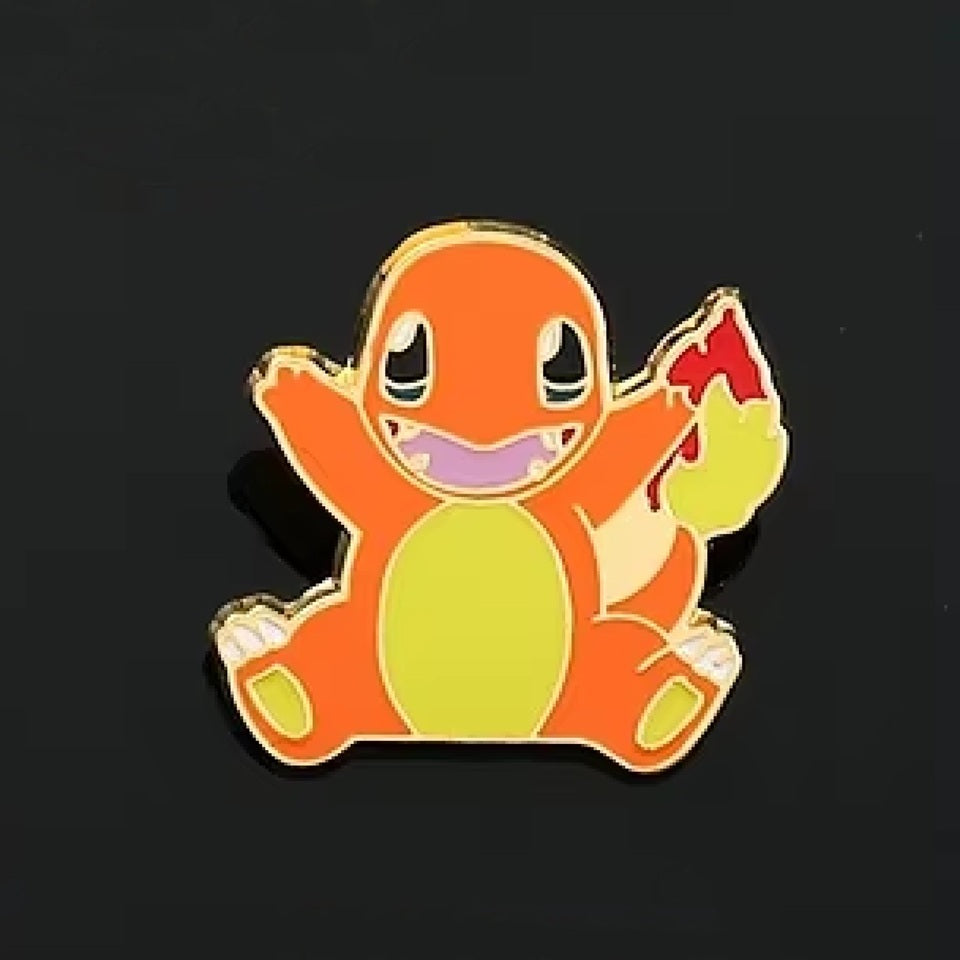 un pin's en forme du charismatique Pokemon Salamèche. On retrouve son design fidèle avec une expression amusante