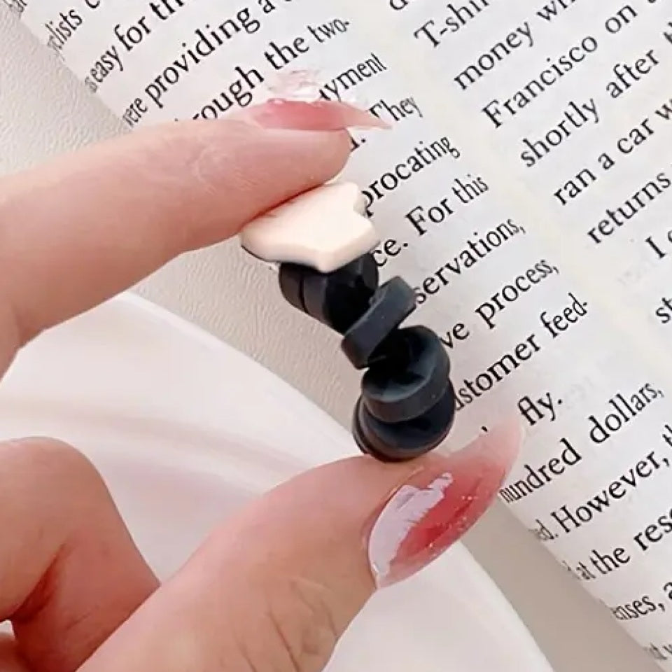 un protège câble en forme de mains qui forment un cœur, le finger heart coréen accompagné d'un joli cœur rouge. Idéal pour protéger et allonger la durée de vie de vos câbles