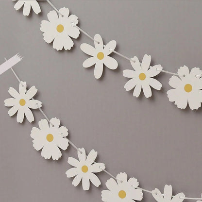 une guirlande en forme de marguerites en papier. De style élégante et bohème, vous pouvez l'utiliser pour un anniversaire ou n'importe quelle fête