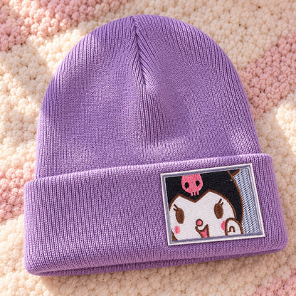 Bonnet violet lavande en maille côtelée douce, avec revers et broderie Kuromi sur le devant. Présenté sur un tapis moelleux rose et crème, ce bonnet kawaii Sanrio est idéal pour garder la tête au chaud avec une touche mignonne et originale.