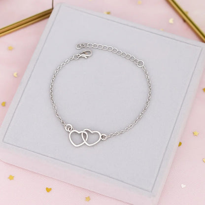 un bracelet argenté représenté deux coeurs entrelacés. Symbole d'amour, d'union éternel