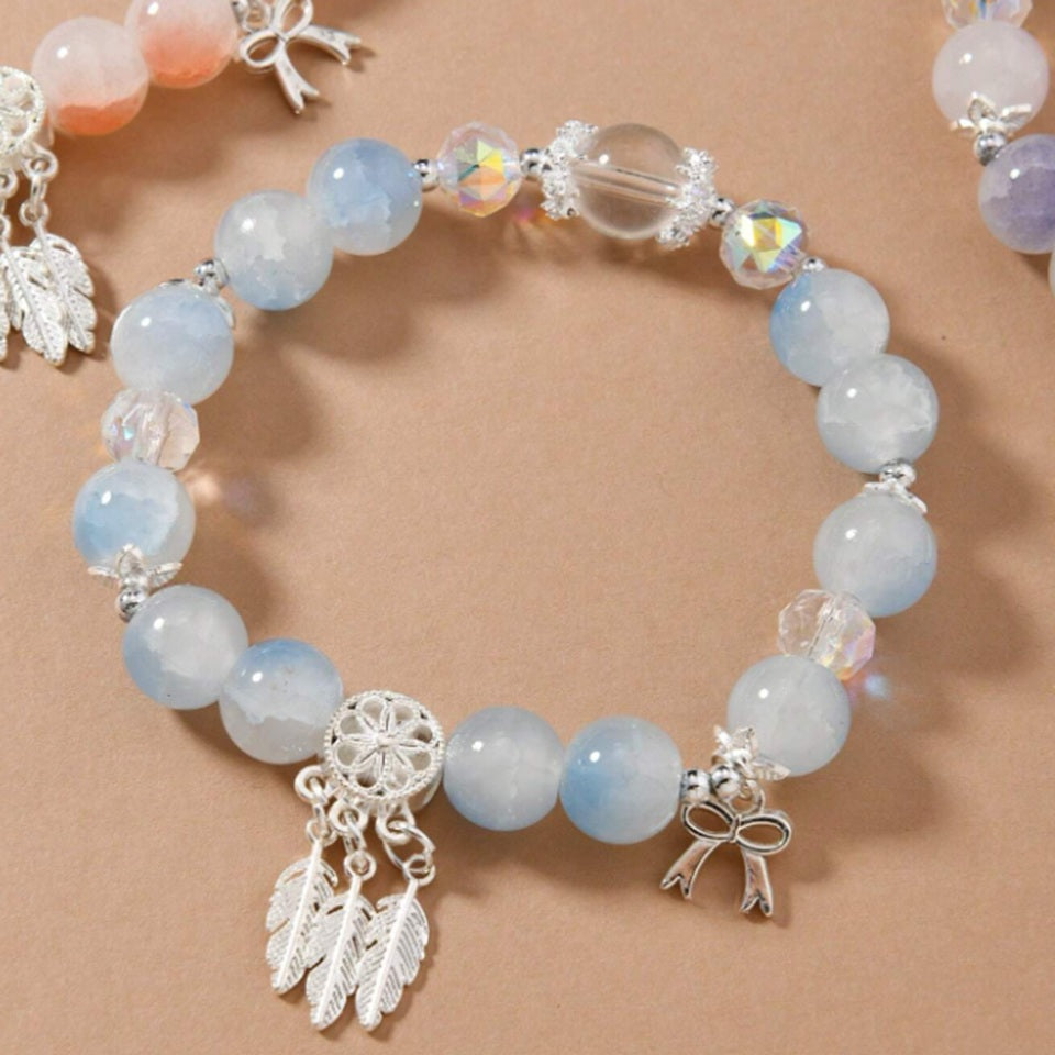 des bracelets composés de perles colorées et scintillantes avec une breloque attrape-rêves. Ensemble et look bohème chic