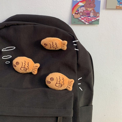 une broche en forme de poisson comme un taiyaki. Tout en peluche, elle est très douce et mignonne.