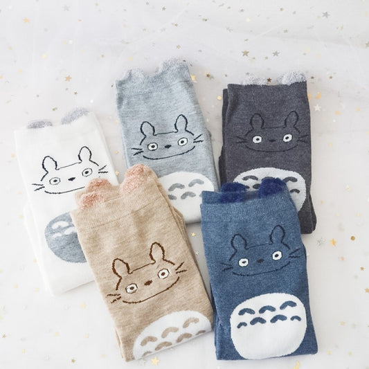 des chaussettes en coton toutes douces et mignonnes inspirées du personnage Totoro du film Mon voisin Totoro. Elles reprennent le design de ce personnage si charismatique et tendre. Retrouvez les chaussettes en coloris blanc, brun, bleu et gris.