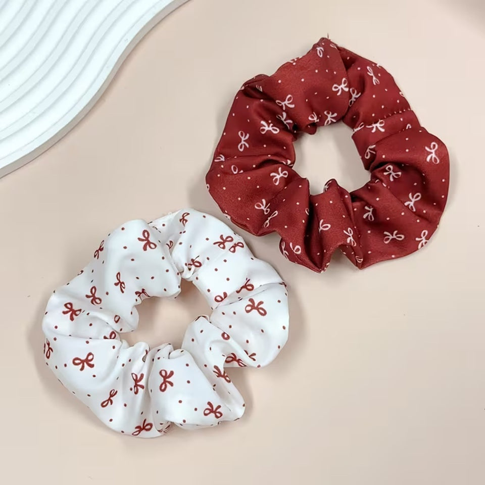 Chouchous cheveux au motif de rubans rouges et blancs, avec un modèle blanc à rubans rouges et un modèle bordeaux à rubans blancs, au style élégant et kawaii.