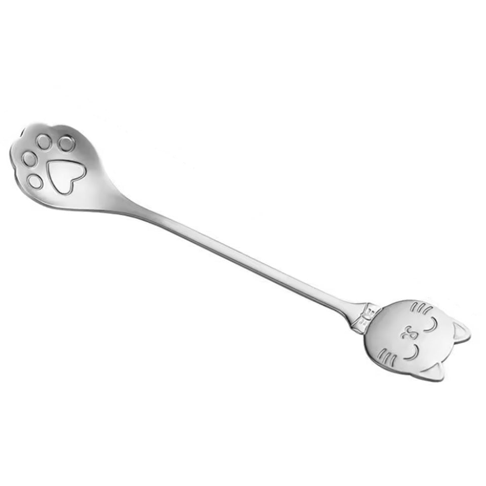 une adorable cuillère en acier inoxydable en forme de patte de chat. Au bout du manche se trouve une tête de chat toute mignonne.