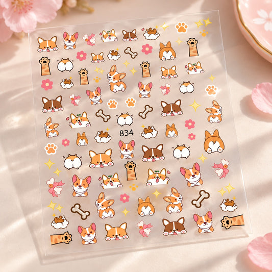 Planche transparente de stickers nail art Corgi kawaii avec petits chiens, pattes, os, fleurs et motifs amusants pour décorer les ongles.
