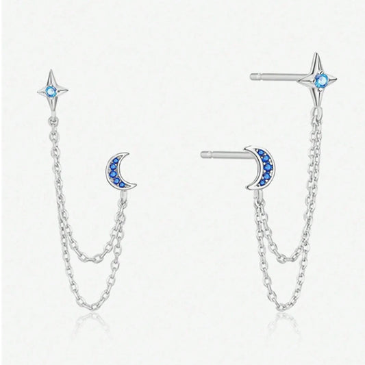une paire de double boucles d'oreilles croissant de lune et étoile tout en strass relié par deux chainettes argentées