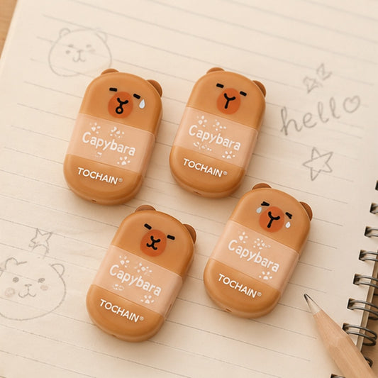 Lot de 4 gommes capybara kawaii sur une feuille quadrillée avec crayon, accessoires de papeterie adorables pour l’école et le bureau.