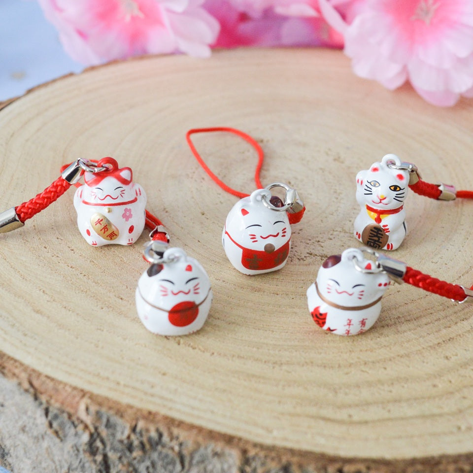 des porte-clés en forme de maneki neko sous forme de grelot. Il y a plusieurs couleurs et designs différents. 