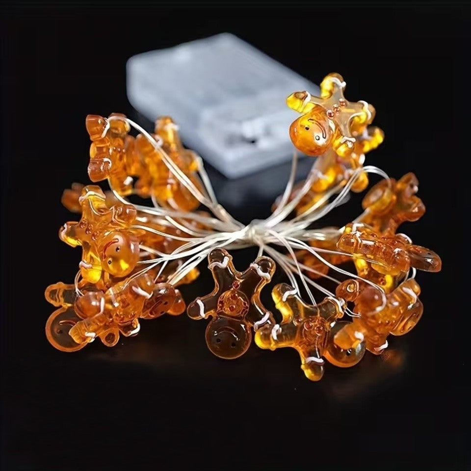 une adorable guirlande LED en forme de bonhomme en pain d'épice. Hyper mignonne, elle fonctionne à piles et sa douce lumière chaude crée une ambiance cocooning et magique. Idéale pour décorer une table de Noël ou une chambre.