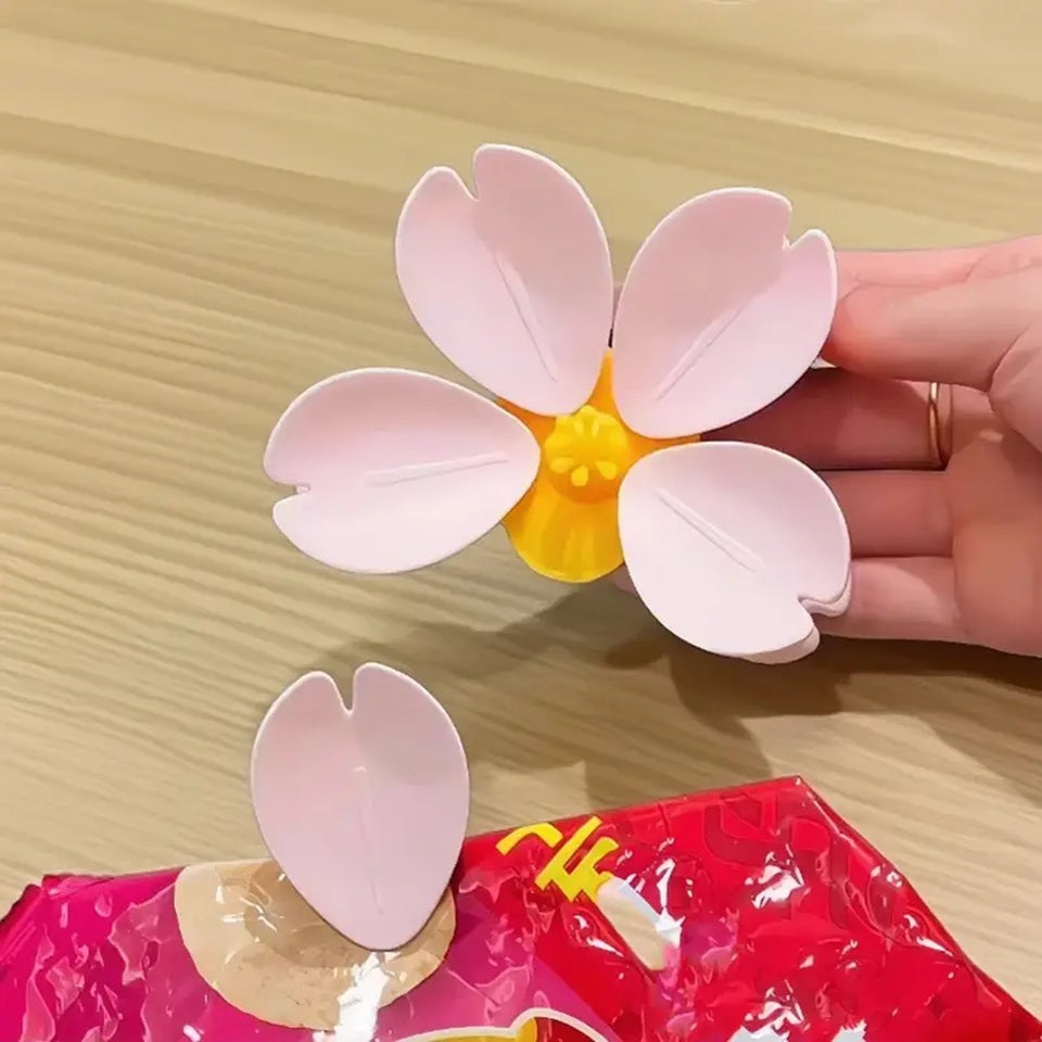 un magnet en forme de fleur de sakura : son coeur est mangnétique et cinq pétales détachables l'entoure. Ce sont des pinces que l'on utiliser pour fermer des paquets de nourriture mais aussi pour tenir des papiers.