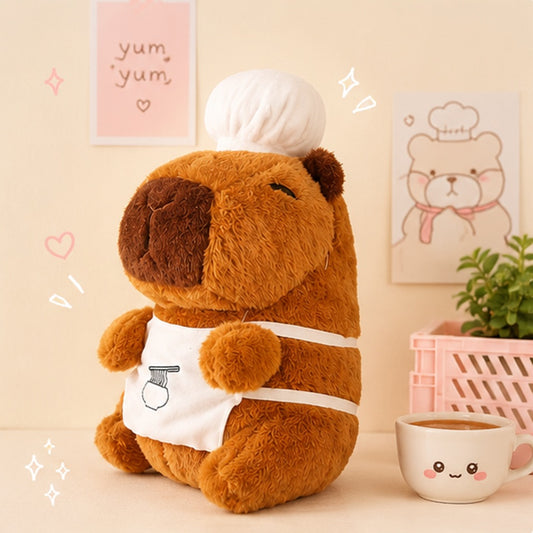Peluche capybara kawaii avec toque de chef et tablier, ultra moelleuse, dans une ambiance cocooning 🦫