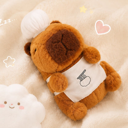 Peluche capybara chef kawaii vue de face, expression calme et mignonne, toque blanche et tablier 🦫
