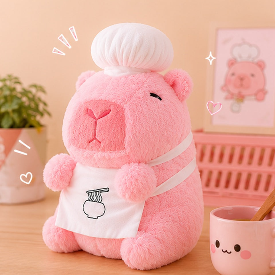 Peluche capybara chef rose kawaii vue de face, expression calme et mignonne, toque blanche 🦫