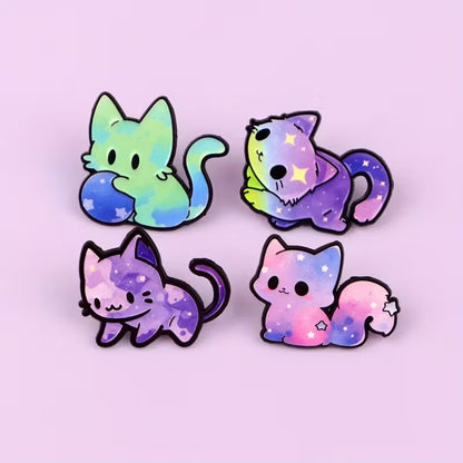 des jolis pin's en forme de chat et aux couleurs de la galaxie : vert, rose bleu, violet. Ils transcendent le caractère mystérieux et imprévu du chat.