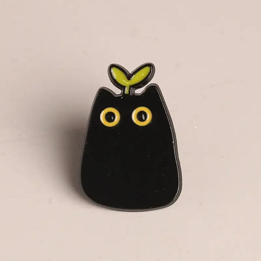 Pin's chat noir et sa feuille