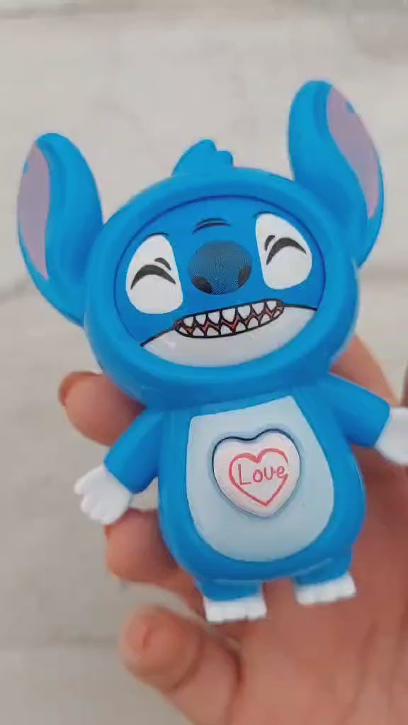 un porte-clés en forme de Stitch de Lilo et Stitch. Il a un petit coeur sur le ventre qui permet de changer son expression de visage. Tant espiègle, tnatot amoureux, il est trop adorable !