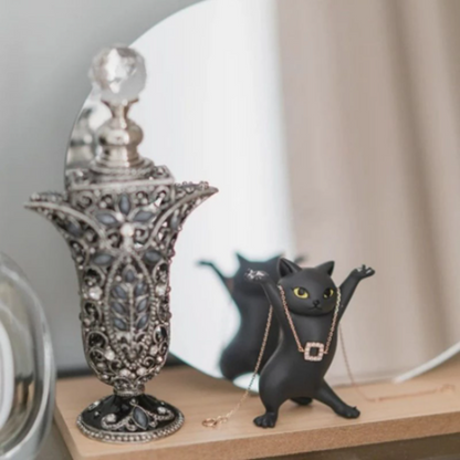 des supports amusants et mignons en forme de chat de plusieurs couleurs. Leurs bras levés vous permet d'y déposer écouteurs, bijoux et tout autre petits objets. Stylé comme élément de décoration.