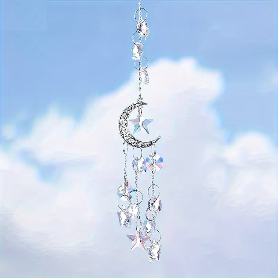 une superbe suspension composée de strass, d'étoiles et d'n croissant de lune argenté. La suspension capte la lumière pour créer de subtils effets lumineux.