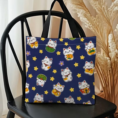 un adorable tote bag bleu illustré de maneki neko trop mignons et d'étoiles jaunes.
